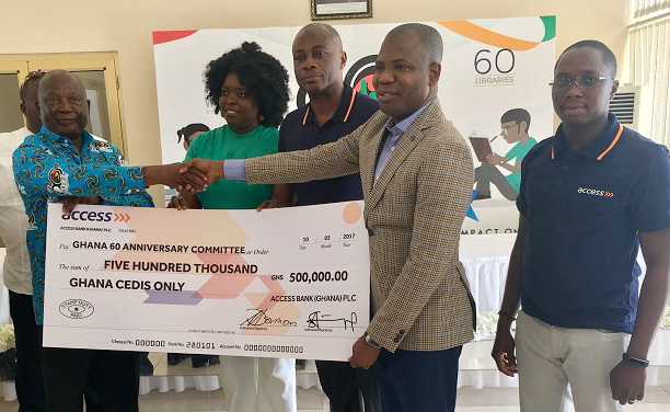 Mr Stephen Abban (2nd right) presenting a dummy cheque to Mr Ken Amankwah. 